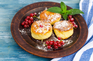Dairy products, cottage cheese pancakes with powdered sugar and berries