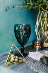 Beautiful decorated wedding table with bridal bouquet, flowers, glass, candles