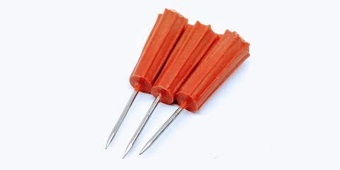 A picture of three paper pins isolated on white background