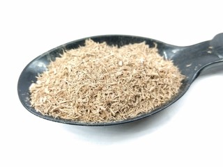 A picture of wood powder on black spoon