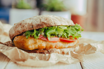 fried fish Sandwich with lettuce, tomato with tartar sauce. author's recipe street food