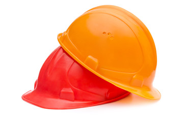 Two hard hats for workers on white.