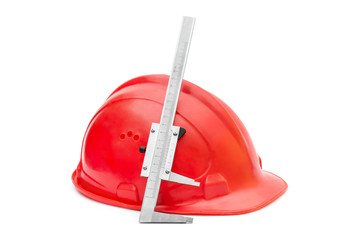 Safety hard hat with vernier caliper on white.