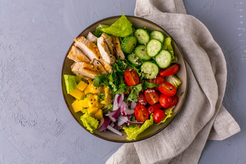 Grilled Chicken Mango Salad with cilantro, cucumbers, cherry tomatoes and red onion