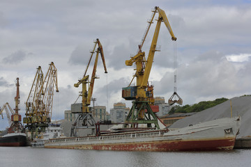 Fototapeta premium Industrial crane for unloading and loading in the river port