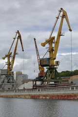 Fototapeta premium Industrial crane for unloading and loading in the river port