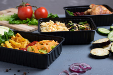 business lunch in food boxes, roast chicken wings, steamed vegetables, stewed meat, ready meal to eat