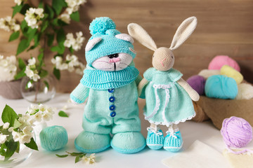 Knitted toy cat and rabbit Handmade on wooden table. Crochet stuffed animals.