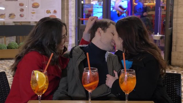 polyamory, unconditional love for three.Three people drinking, flirting, kissing