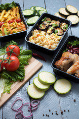 business lunch in food boxes, roast chicken wings, steamed vegetables, stewed meat, ready meal to eat