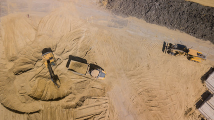 Top view of excavator working in construction site.