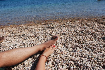 Feet at the beach at Patmos Island in Greece