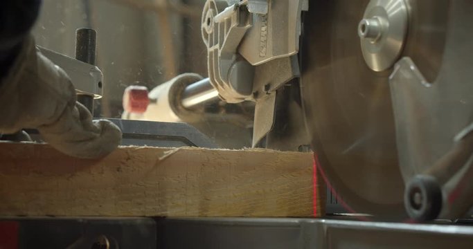 Close-up shot headsaw carving the wood into small squares at manufacture.