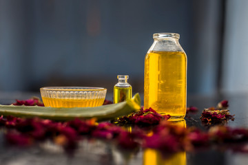 The trio pack of herbs and ingredients to fight dandruff on the wooden surface well mixed in a glass bowl which are castor oil, tea tree oil, and some aloe vera gel. Also used to treat itchiness.;