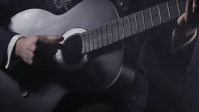 Close up of a man playing black and white guitar, Santa Muerte, 4k