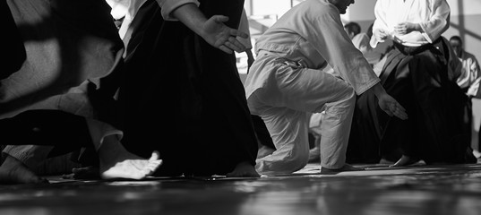 Aikido training. Black and white image. Traditional form of clothing in Aikido. Background image....