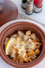 White fish baked with potatoes and a cheese