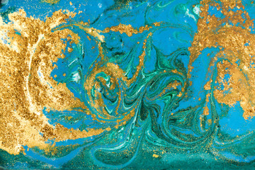 Fototapeta na wymiar Liquid uneven blue and green marbling pattern with golden glitter and glare of light