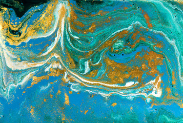 Fototapeta na wymiar Liquid uneven blue and green marbling pattern with golden glitter and glare of light