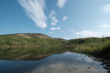 Fototapeta premium Lake surrounded by low mountains