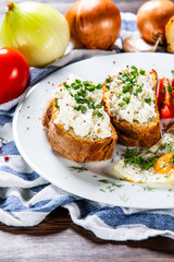 Breakfast - fried egg, toasts and vegetable salad