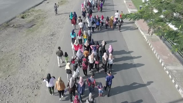 People are walking together on road