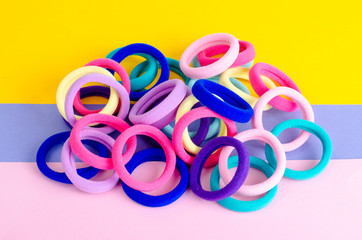 Colored hair ties on bright background. Photo