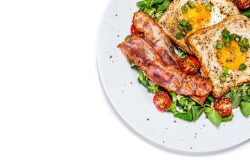 Breakfast - toasted bread with fried egg, bacon and vegetables