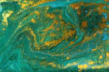 Liquid uneven green marbling pattern with golden glitter and glare of light