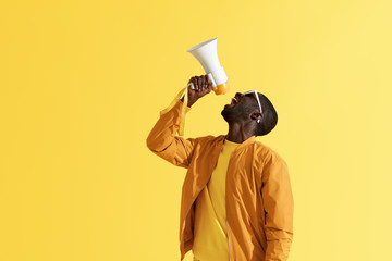 Advertising. Man screaming announcement in megaphone portrait