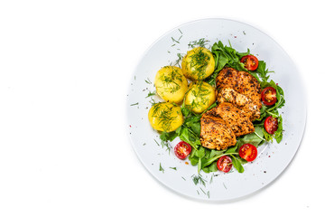 Grilled chicken fillet and vegetables on white plate