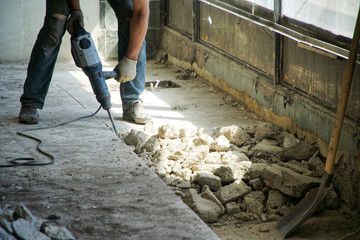 Repair using a perforator in a store or other public institution. Opening the cement floor