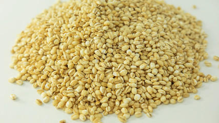 Stack of raw barley with hull removed, whole-grain cereal product with excellent nutritional values, helping with blood pressure, weight control and satiety, heart and bone health and digestion issues