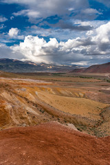 Mountain landscape. Colored mountains. Clay mountains. Cloudy sky. Altai.