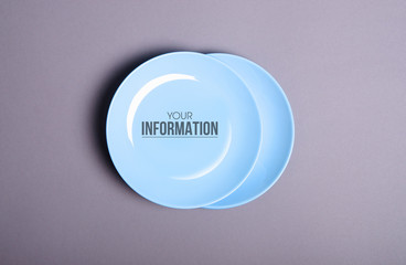 Blue empty plate on gray background, space for text