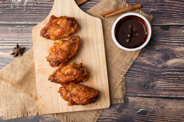 Hot and spicy Korean barbeque fried chicken on wood cutting board