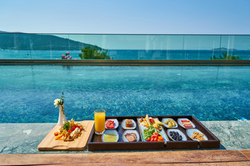 Breakfast in luxury hotel pool