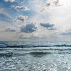 dramatic low clouds over the sea with waves