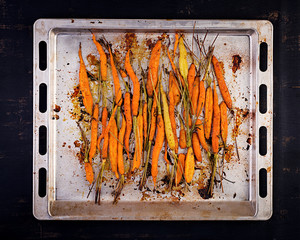 Baked organic carrots with thyme, honey and lemon. Organic vegan food. Top view