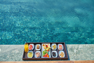 Fototapeta na wymiar Breakfast in luxury hotel pool