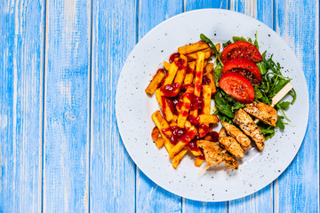 Fried chicken strips,french fries and vegetables