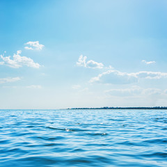 Obraz premium blue sea and low clouds in sky above it