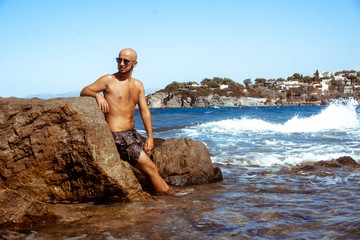 handsome man on the marine rocky shore