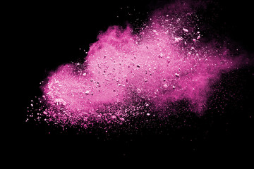 Pink powder explosion on black background. Paint Holi.