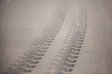 Traces of the wheels on the pavement. Track from car tires. Rubber from the wheels remains on the surface. Strong braking. The result is great speed.