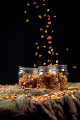 corn grain falls on glass jars