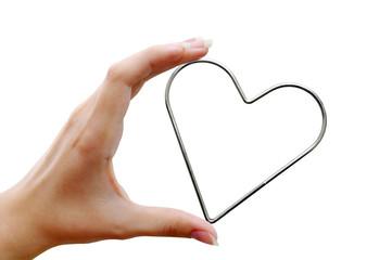 Metal heart in female hand