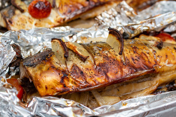 Fried mackerel on the foil with lemon and cherry tomatoes healthy delicious tasty food close up selective focus
