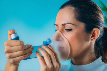 Woman Using Inhaler for Asthma