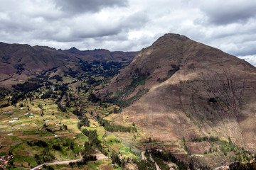 View of Pisac Archaeological Park and green mountains of the Sacred Valley of the Incas, Peru